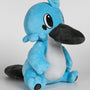 Image shows Temtem Platypet Plush facing at a right angle. Product features its black tail and two small black, oval spots that sit on the outer side of the eyes. 