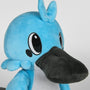 Image shows Temtem Platypet Plush facing front at a left angle. Product has either side of its head having three round tufts of fur with the middle tuft being bigger than the outer two. 